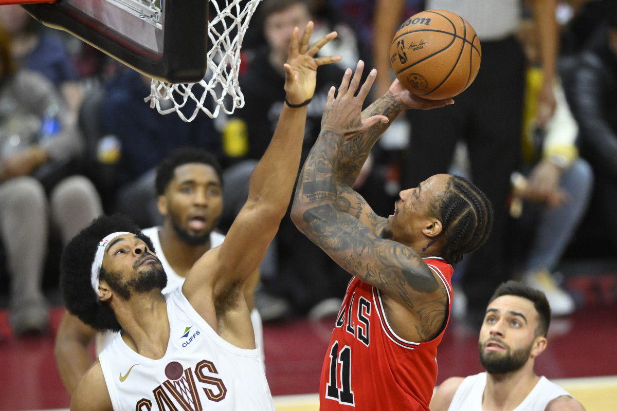 Jan 15, 2024; Cleveland, Ohio, USA; Chicago Bulls forward DeMar DeRozan (11) shoots beside Cleveland Cavaliers center Jarrett Allen (31) in the fourth quarter at Rocket Mortgage FieldHouse.